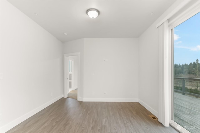 unfurnished room with wood-type flooring