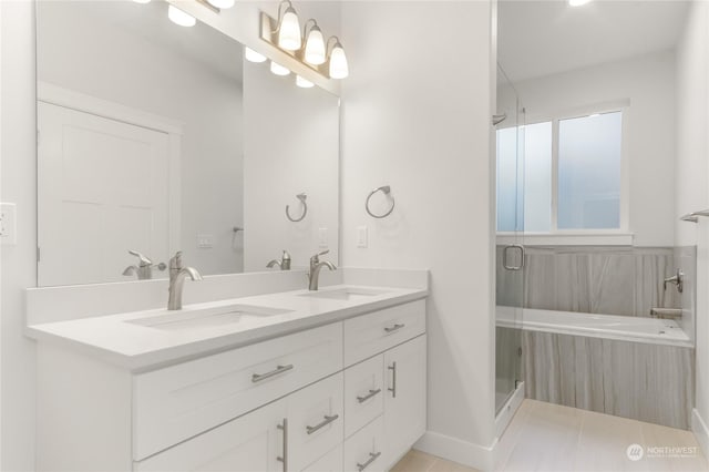 bathroom featuring walk in shower, vanity, and tile patterned flooring