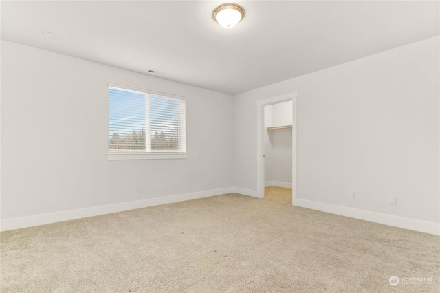 unfurnished room with light colored carpet