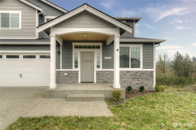 property entrance featuring a garage and a yard