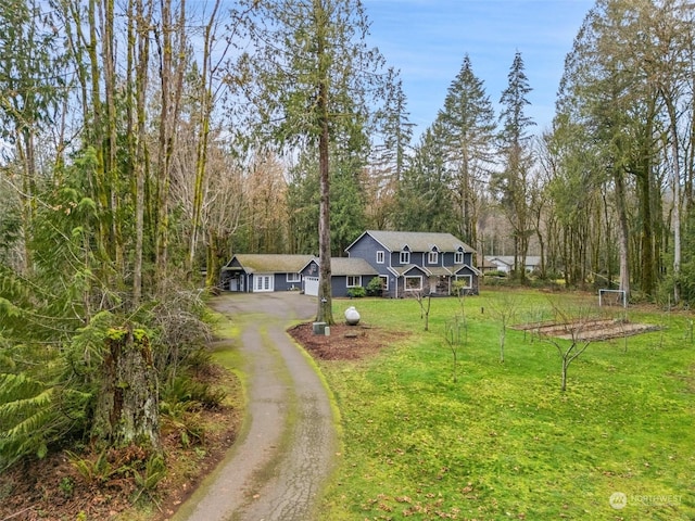 view of front of property with a front yard and a garage