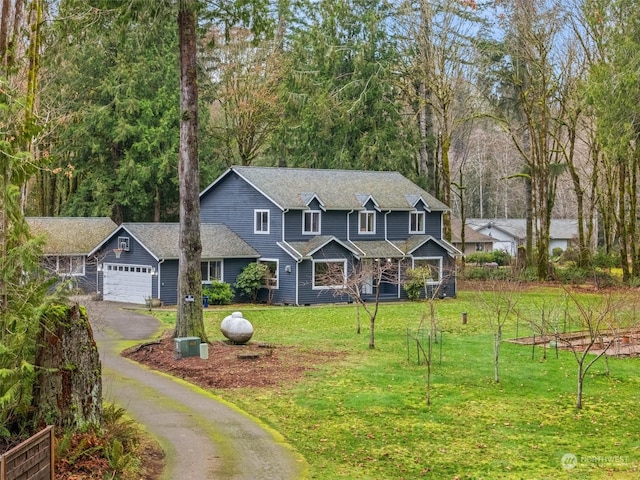 view of front of house with a front lawn and a garage