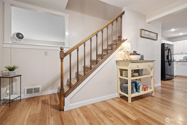 stairway featuring wood-type flooring