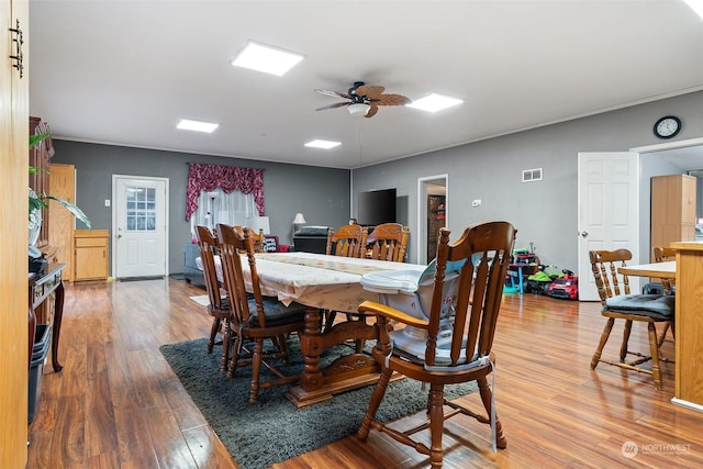 dining room with ceiling fan and light hardwood / wood-style floors