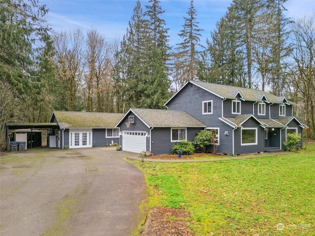 view of front of house featuring a carport, a front lawn, and a garage