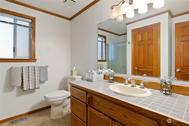 bathroom with ornamental molding, vanity, an enclosed shower, toilet, and tile patterned floors