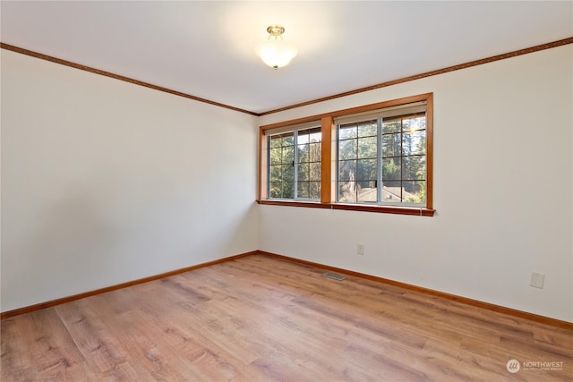 unfurnished room with crown molding and light hardwood / wood-style flooring