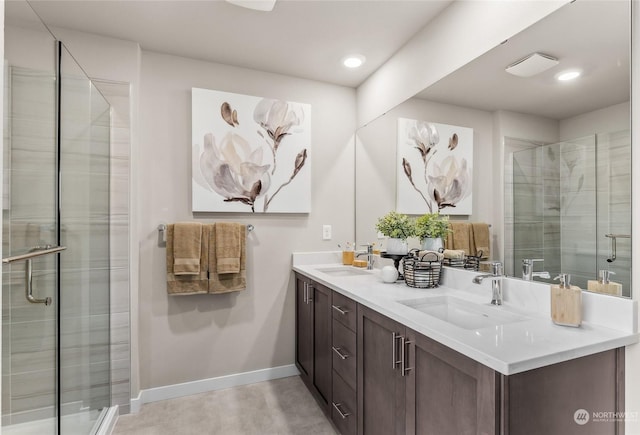 bathroom featuring vanity and a shower with shower door