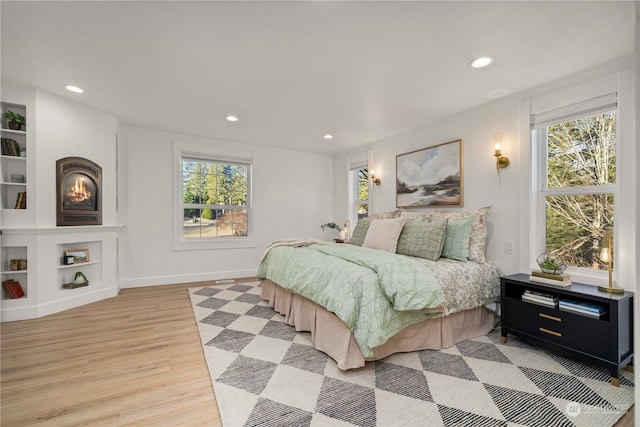 bedroom featuring light hardwood / wood-style floors and multiple windows