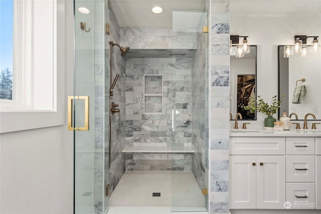 bathroom with a shower with door and vanity