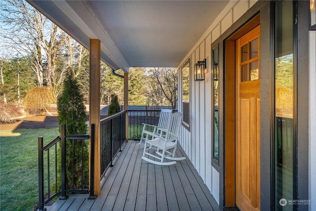 deck featuring a yard and covered porch