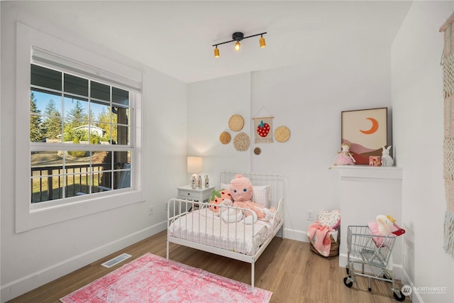 bedroom with hardwood / wood-style flooring