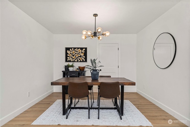 dining room featuring a notable chandelier and light hardwood / wood-style floors