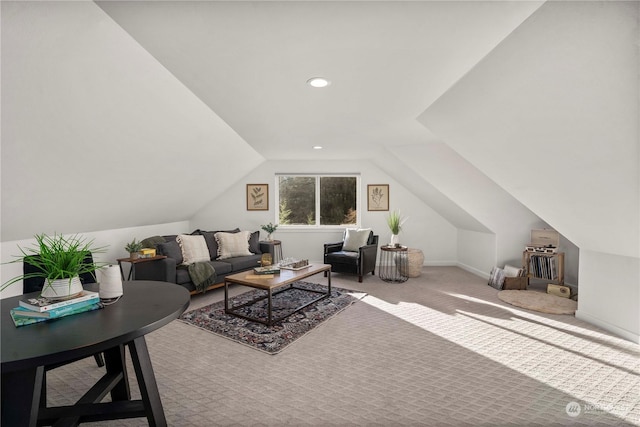 carpeted living room with lofted ceiling