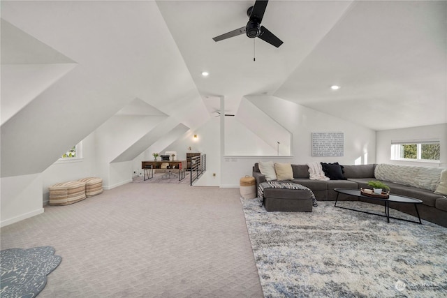 carpeted living room featuring ceiling fan and vaulted ceiling