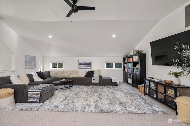 carpeted living room featuring ceiling fan and lofted ceiling