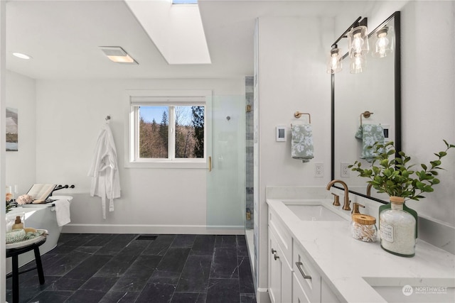 bathroom with vanity, a skylight, and walk in shower