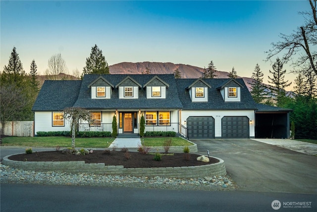 29126 322nd Ave SE, Ravensdale, WA 98051 - view of front facade with a carport, aphalt driveway, fence, a porch, and a garage
