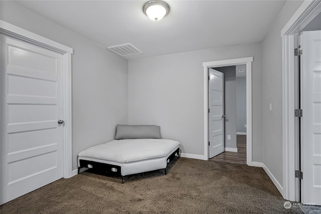 living area with dark colored carpet