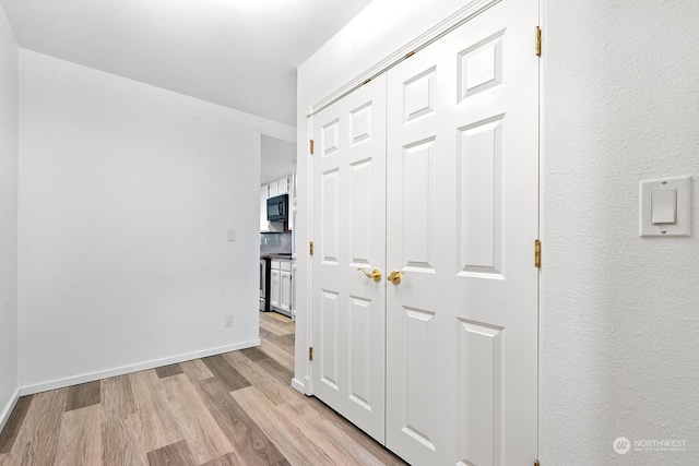 hallway with light wood-type flooring