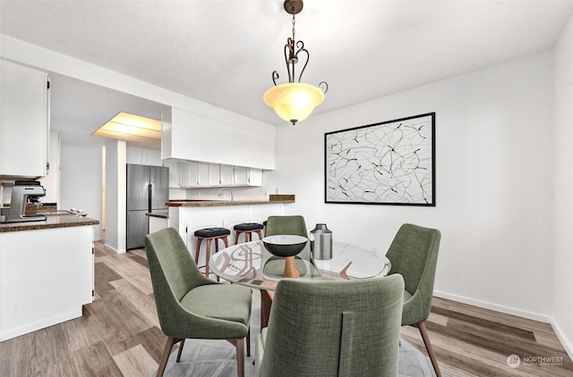 dining space featuring light hardwood / wood-style floors