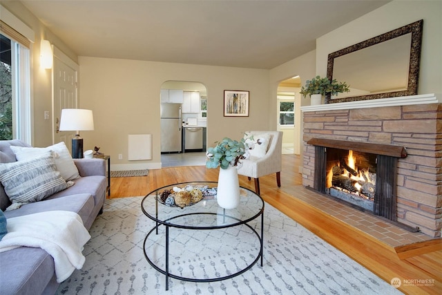 living room with light hardwood / wood-style flooring and a fireplace