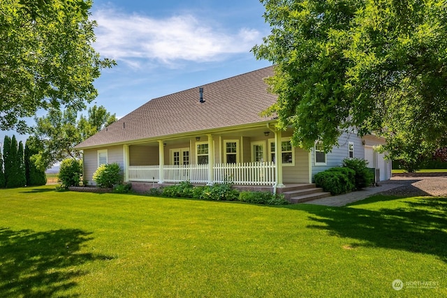 view of front of house featuring a garage, a porch, and a front yard