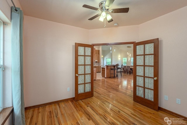 spare room with ceiling fan, light hardwood / wood-style floors, and french doors