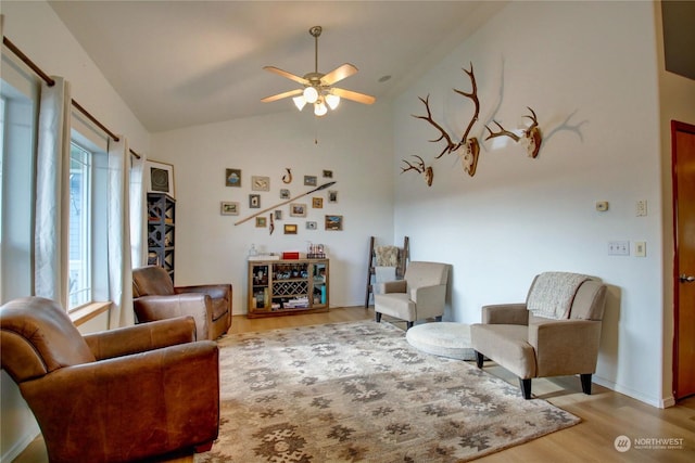 sitting room featuring vaulted ceiling, ceiling fan, light hardwood / wood-style floors, and a healthy amount of sunlight