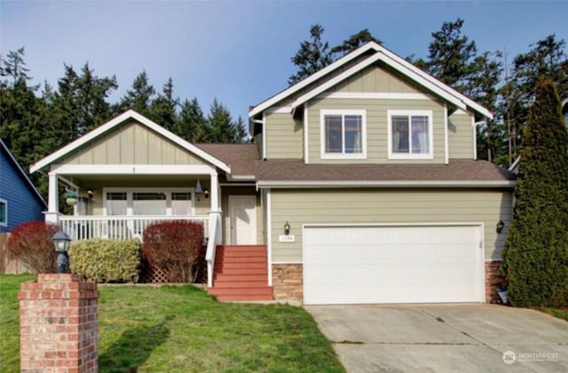 craftsman-style home featuring a front yard, a garage, and covered porch