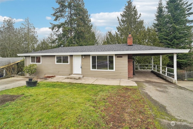 ranch-style house featuring a front yard and a carport