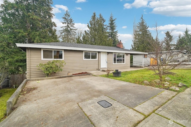 single story home with a front yard and a patio