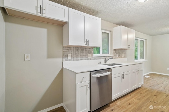 kitchen with white cabinets, dishwasher, backsplash, and sink