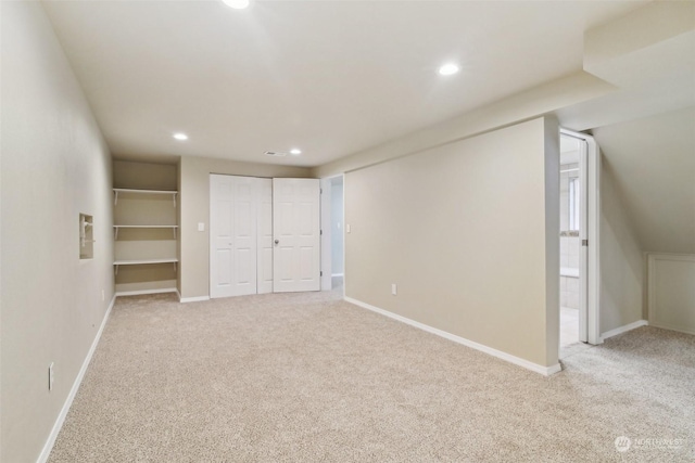 unfurnished bedroom with a closet and light carpet