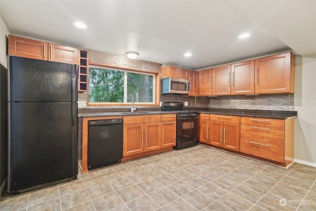 kitchen featuring sink, decorative backsplash, and black appliances