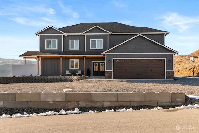 view of front facade featuring a mountain view and a garage