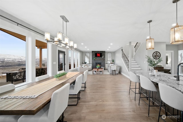 dining space featuring a fireplace and light hardwood / wood-style floors