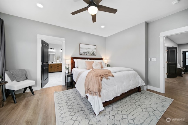 bedroom with light hardwood / wood-style flooring, ensuite bath, and ceiling fan