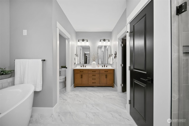 bathroom featuring a bathing tub, vanity, and toilet