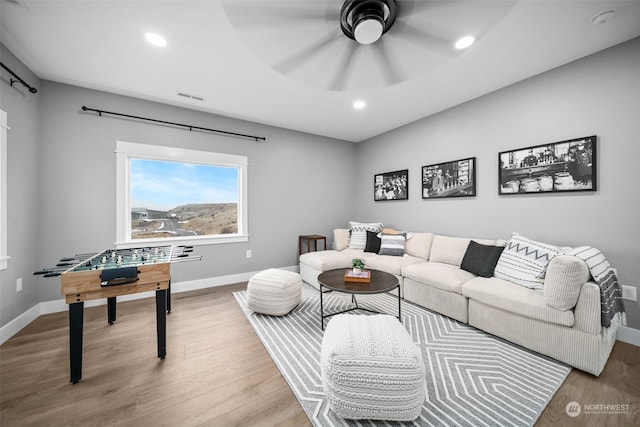 living room with light hardwood / wood-style floors and ceiling fan