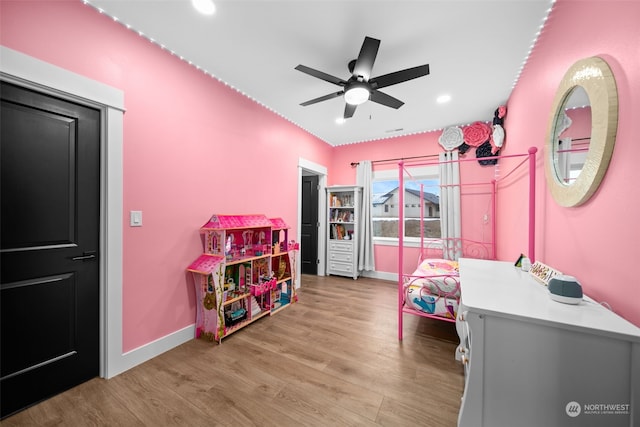 bedroom with ceiling fan and light hardwood / wood-style flooring