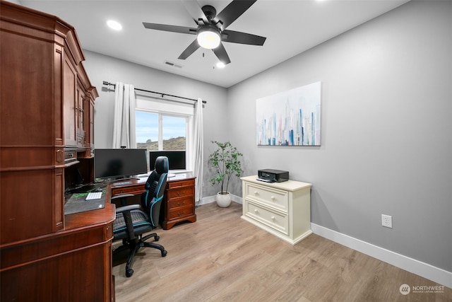 office space featuring ceiling fan and light hardwood / wood-style floors