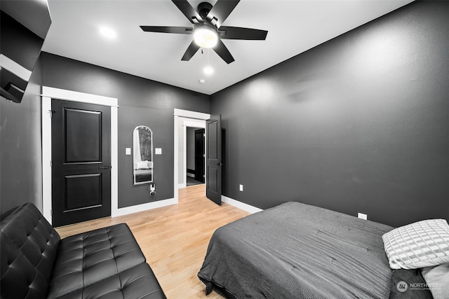 bedroom with ceiling fan and light hardwood / wood-style floors