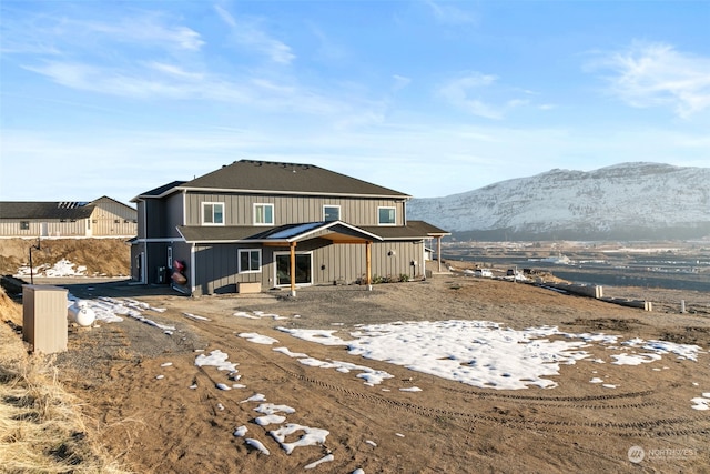 rear view of property featuring a mountain view