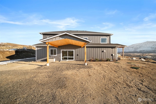 back of house with a mountain view