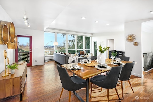 dining space with hardwood / wood-style flooring