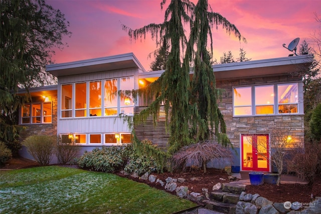 back house at dusk with a yard