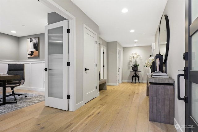 hall with light hardwood / wood-style floors