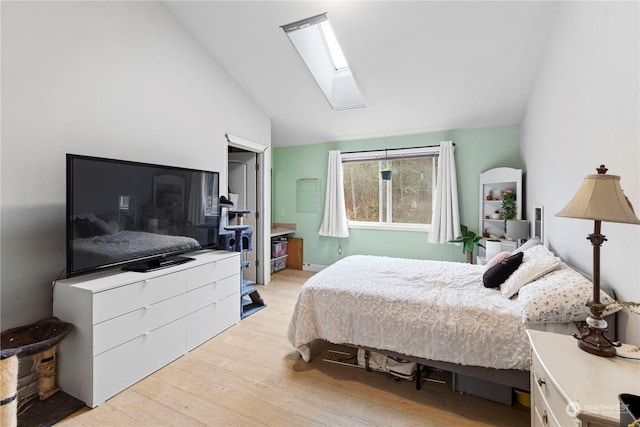 bedroom featuring light wood-type flooring and lofted ceiling with skylight