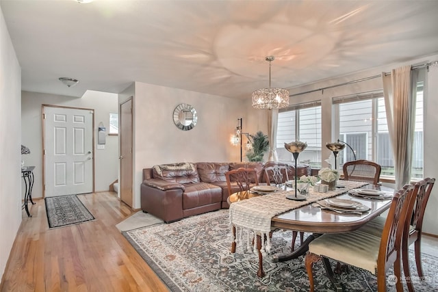 dining room featuring light hardwood / wood-style flooring and a notable chandelier